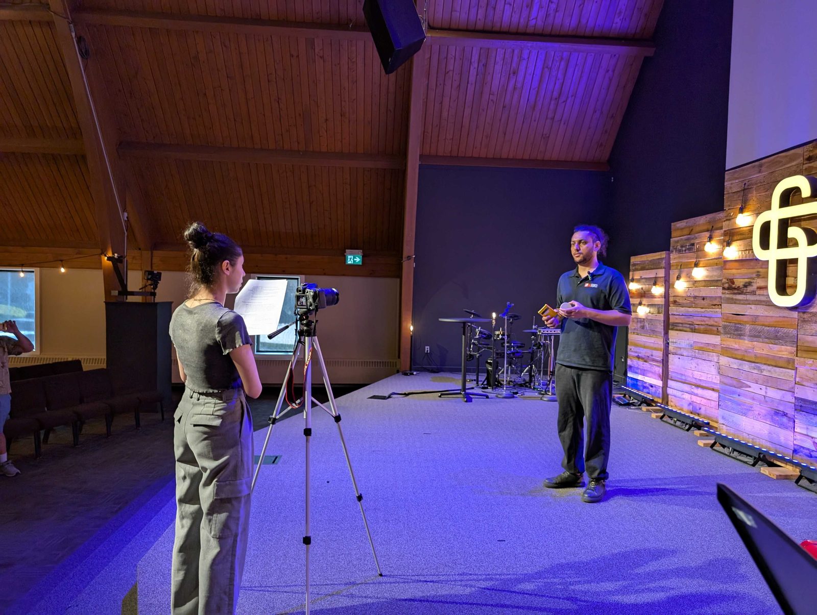 Karan on stage at Grace Church while his team’s content creator films