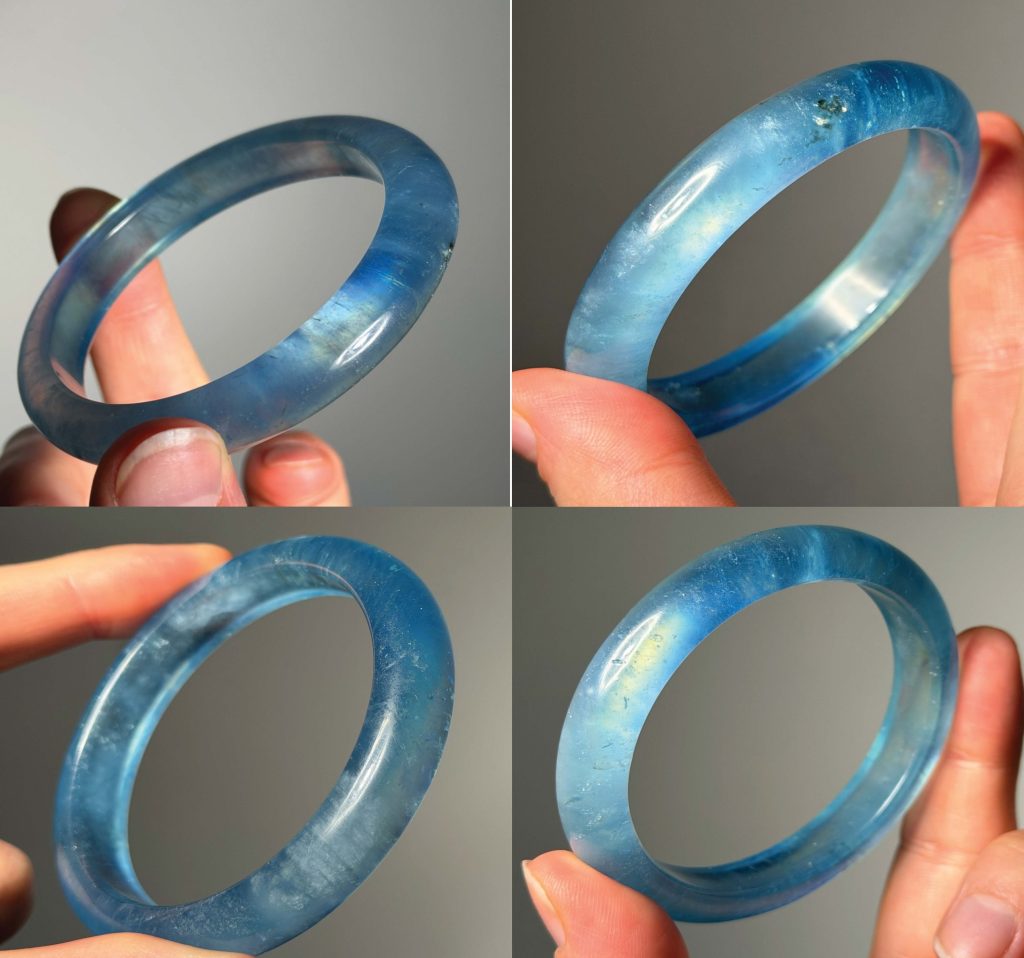 Four real photos of a translucent blue bangle held in the hand, showing its colour, inclusions and polish from different angles.