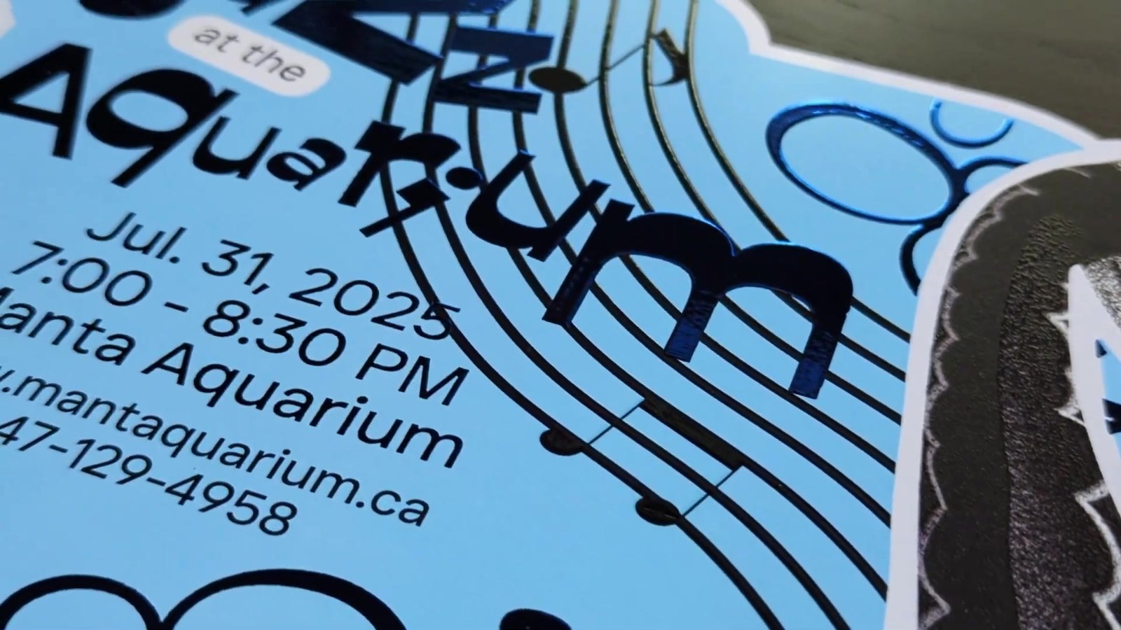 Close up of the magnet: blue foil on the type and bubbles, raised texture on the fish