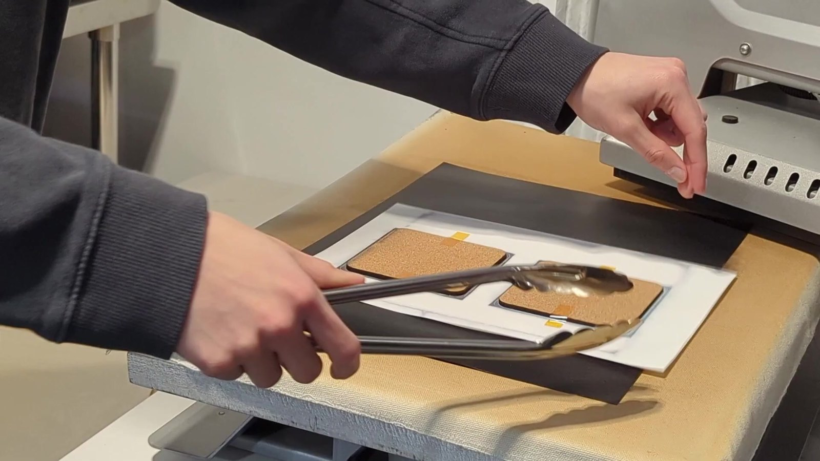 Erik placing coasters on the heat press