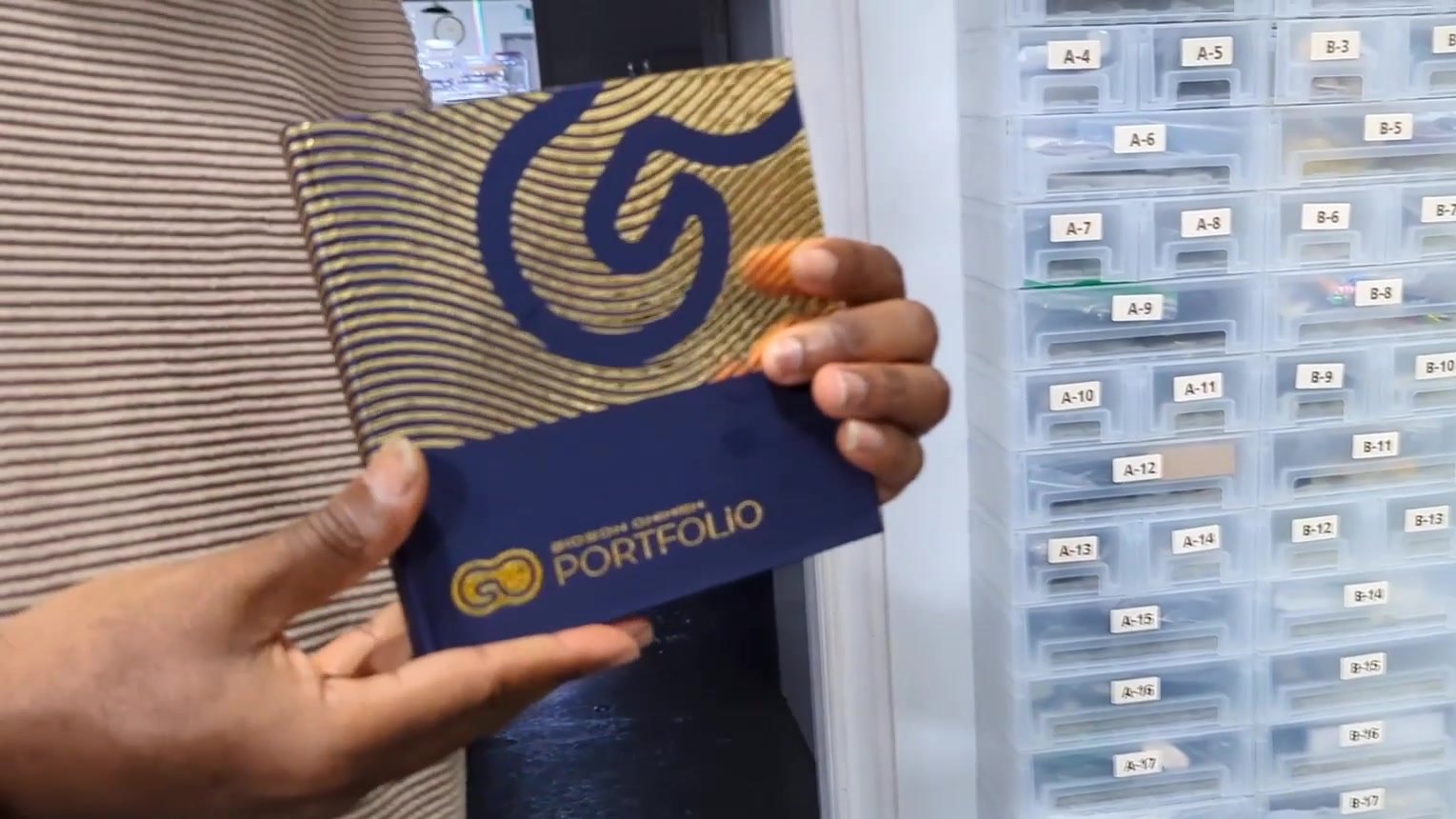Gideon’s hardcover videoBOOK, a gold foil wave forming his G mark on a navy cover