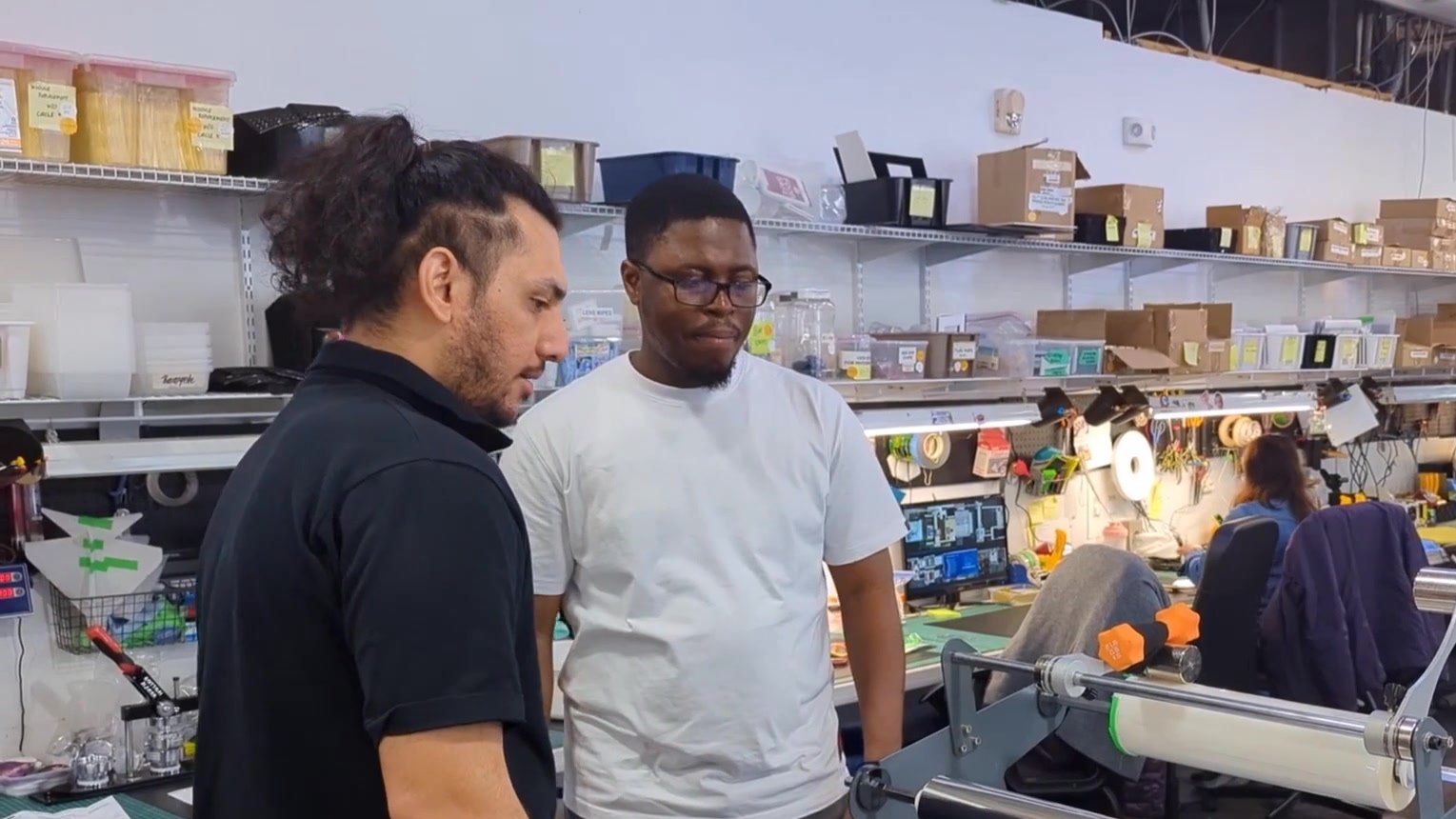 Karan and Gideon on the production floor
