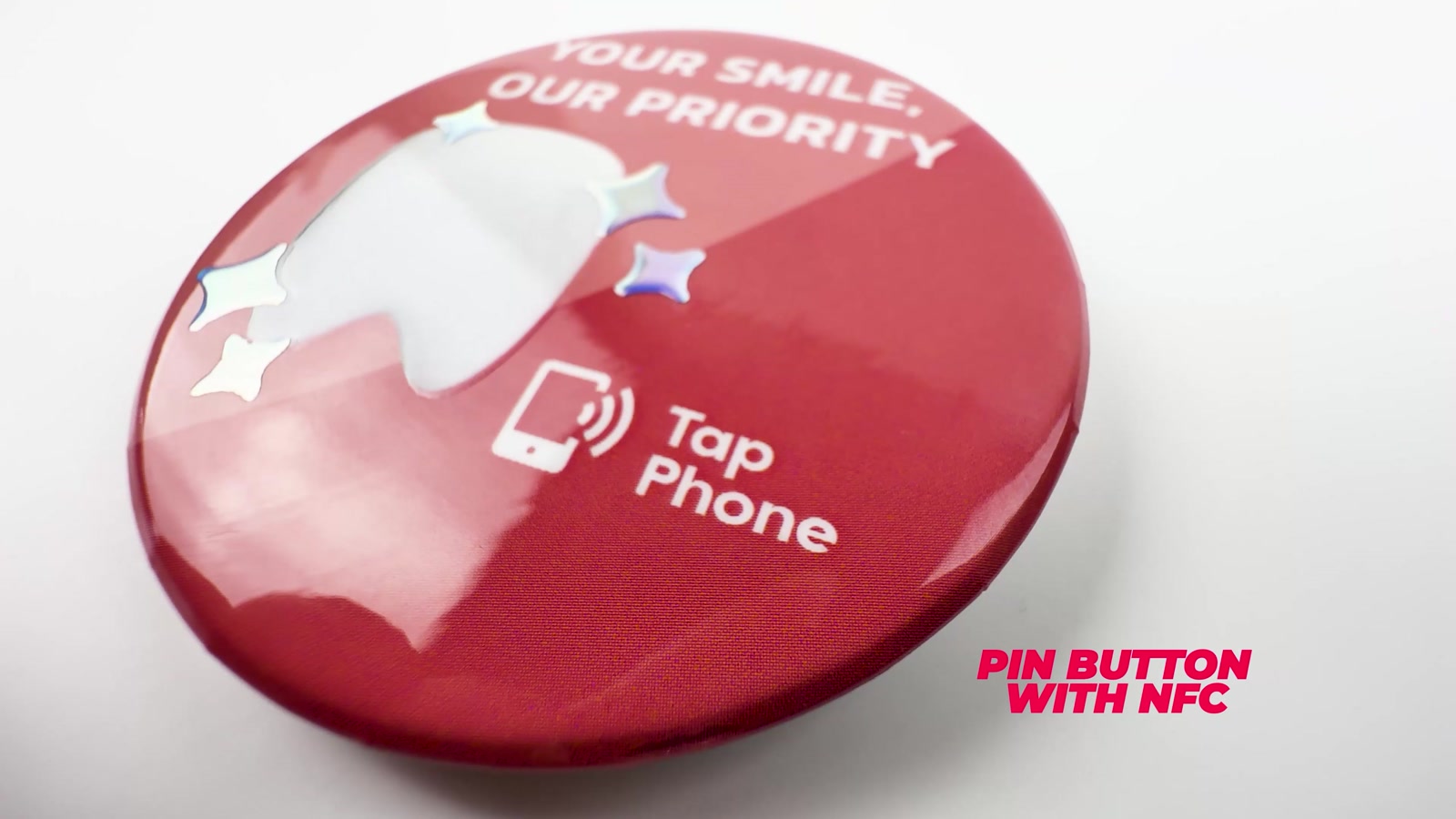 Video frame: a pin button with an NFC chip, labelled Tap Phone