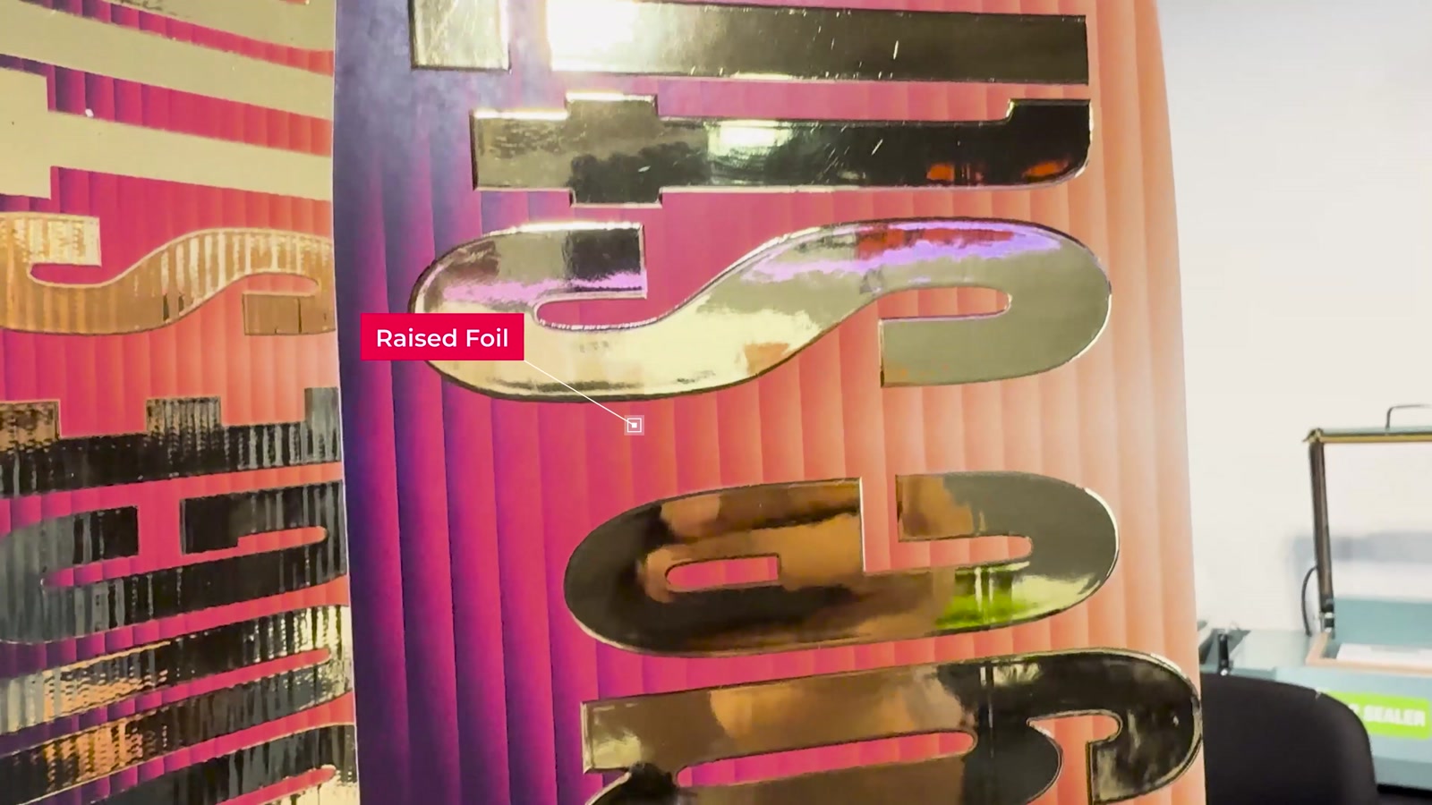 Video frame: raised gold foil on a printed vinyl banner