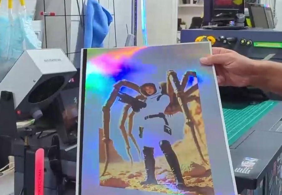 First pass printed on a holographic foil sheet, the foil still showing where the art leaves it open