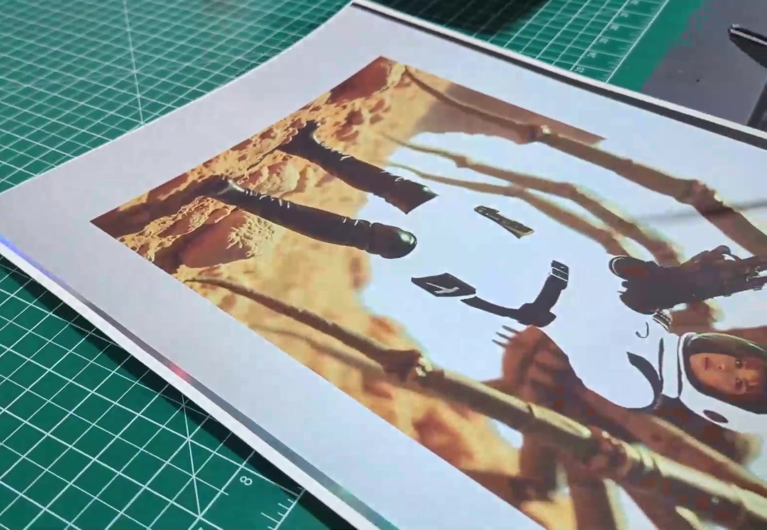 The same sheet after soft touch lamination, the holographic foil muted to near white