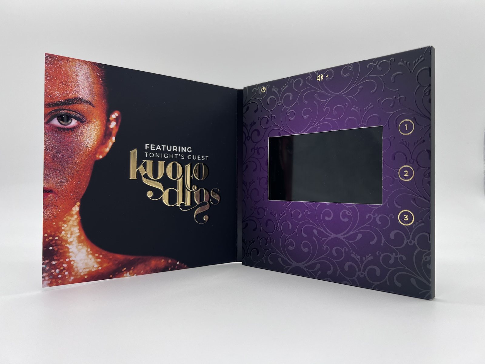 Printed sample of the video card standing open, with sample artwork on the cover and the screen inside