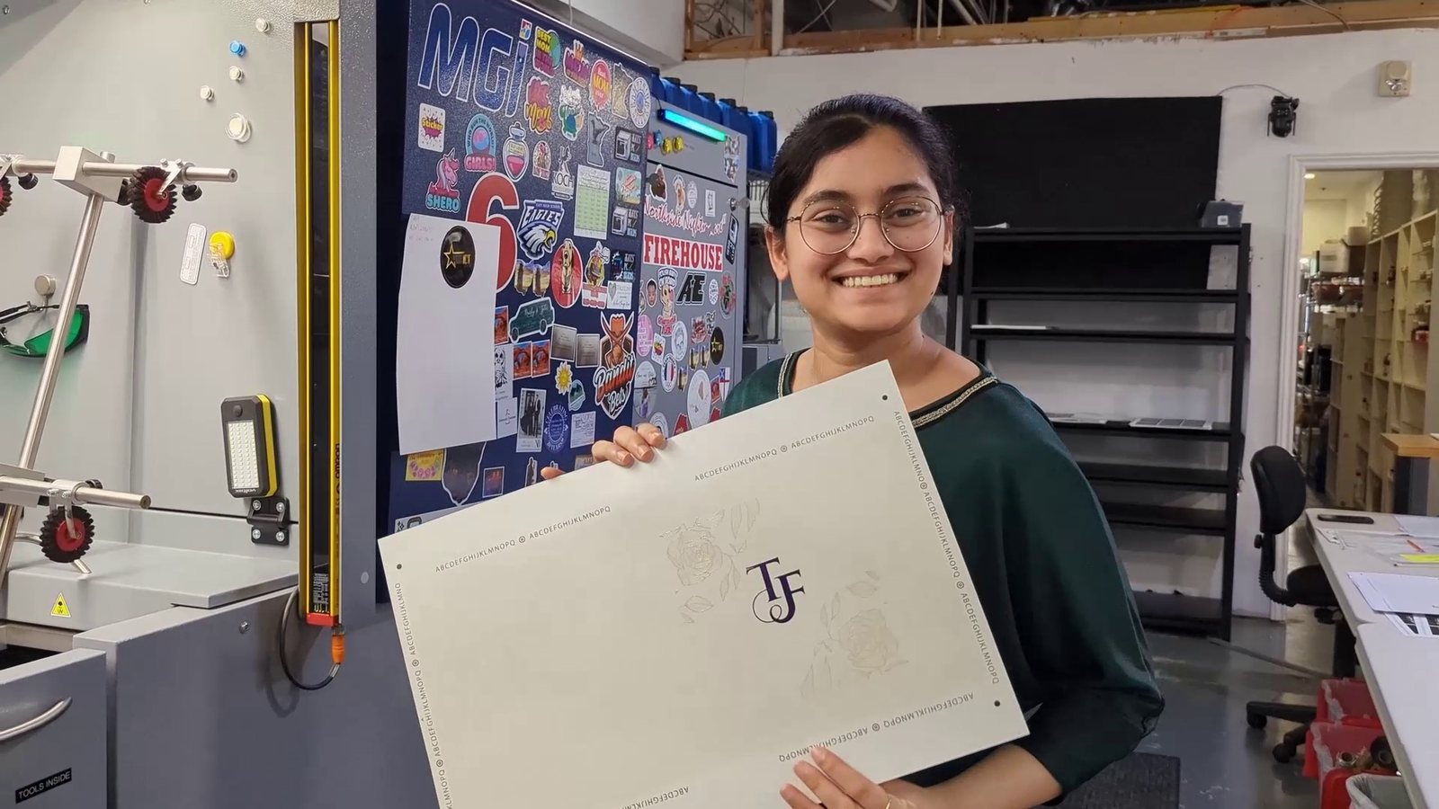 The intern holding the printed and foiled vinyl wrap sheet
