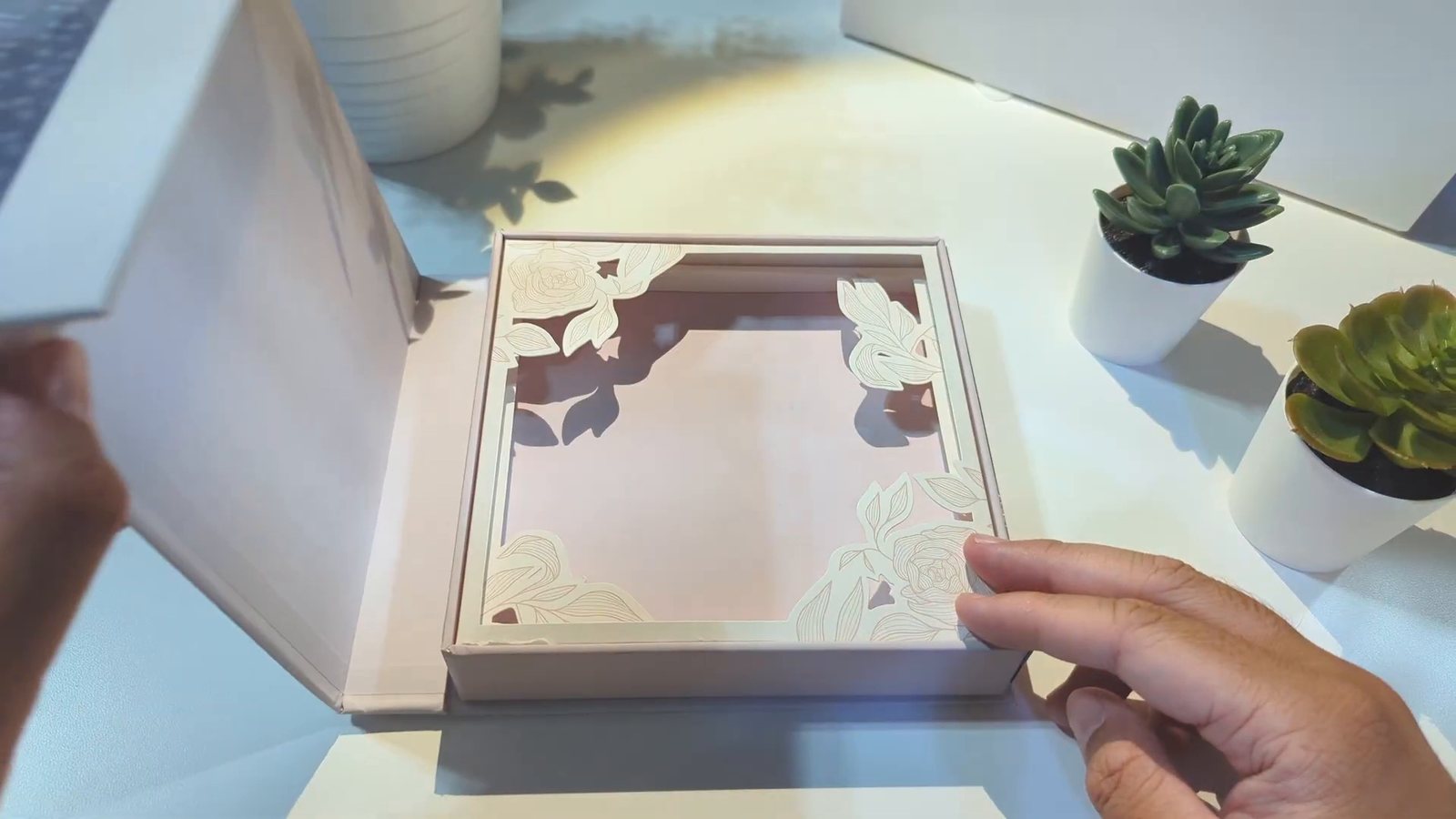 The box open, showing the layered die cut floral frame inside the lid