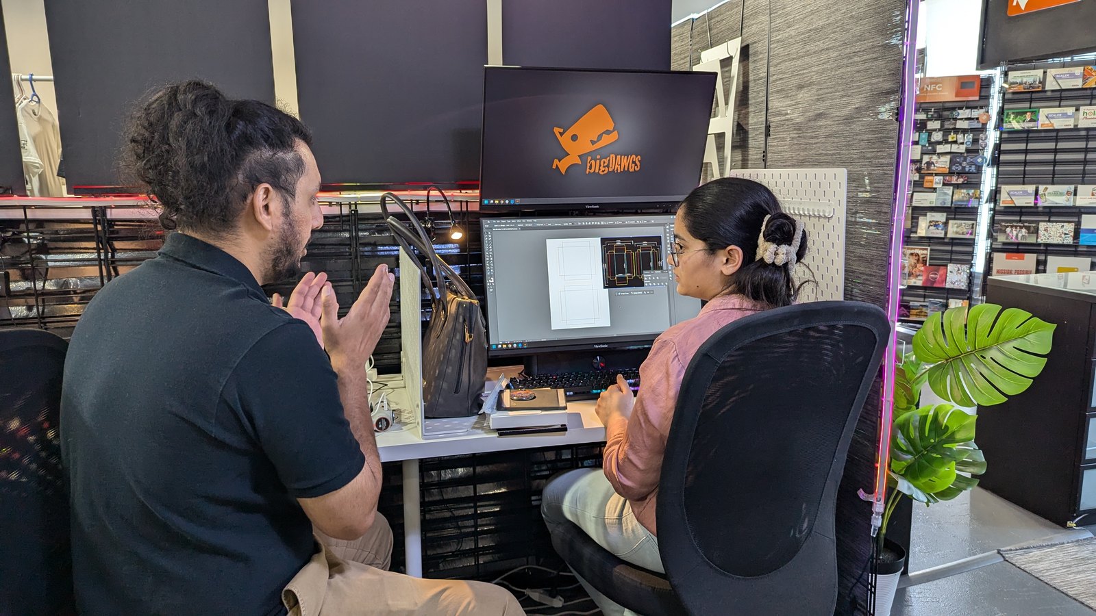 Karan giving Sana feedback on her design at her desk