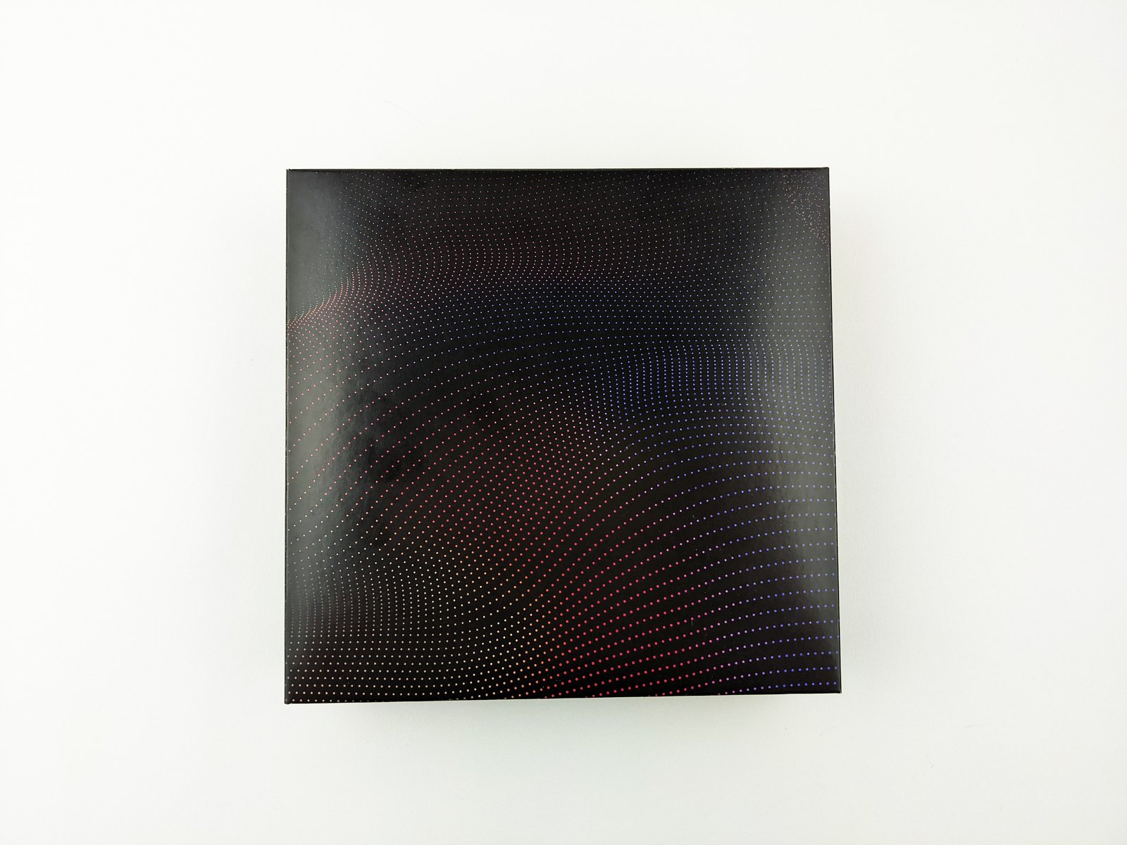 The closed presentation box for the American Influencer Awards nominees, a black lid with a fine dot pattern